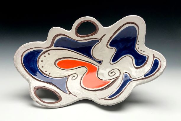A colorful, abstract, ceramic plate