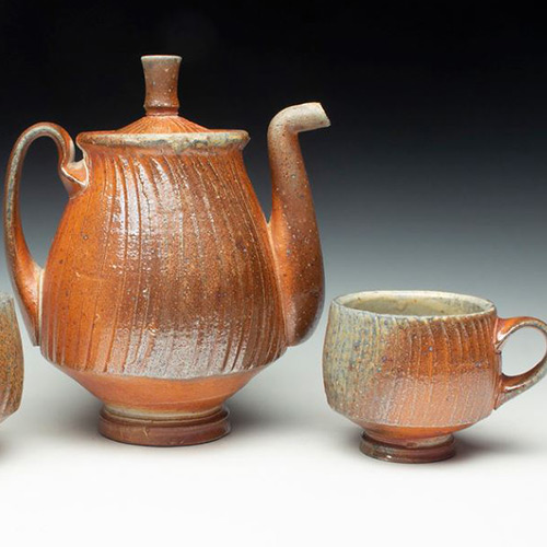 A ceramic pitcher and cup.