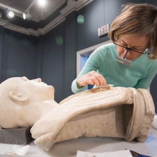 Conservator Amy Jones Abbe gives the Bust of an Unknown Roman a careful cleaning as part of her residency at University Museum.