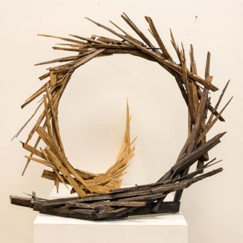 Scultpure of wooden sticks formed into an upright circle